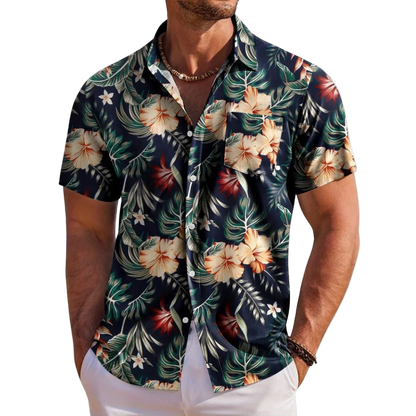 Man wearing a tropical floral patterned shirt on a white background