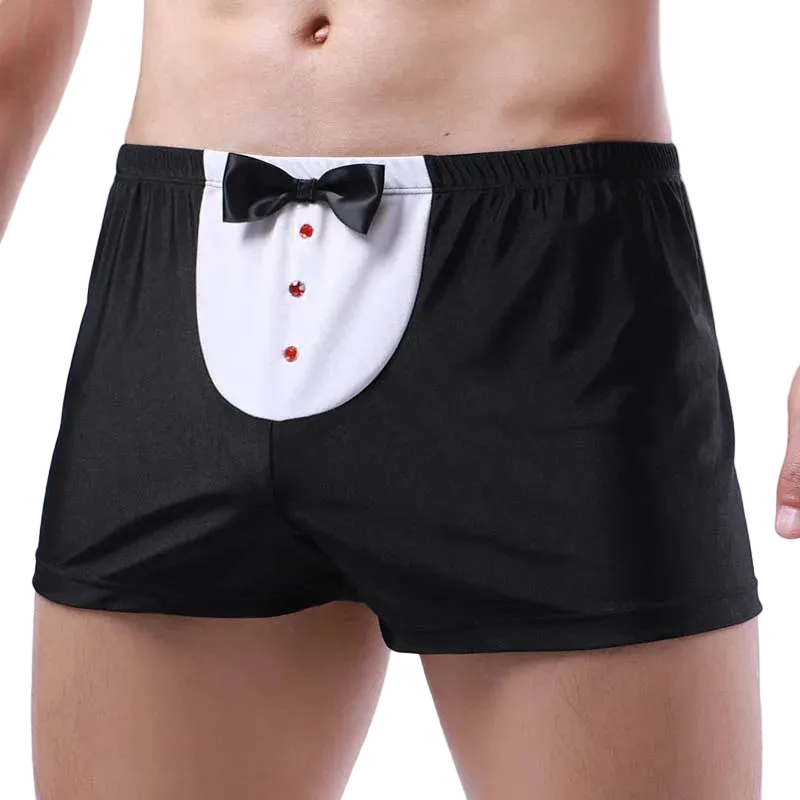 Black boxer briefs with a tuxedo-style front panel featuring a white yoke, black bow tie, and red decorative buttons, shown on a cropped male model against a white studio background.