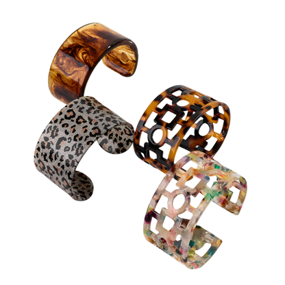 Bold leopard print wide cuff bangle featuring hollow geometric patterns and premium resin design for resort wear and theme nights

