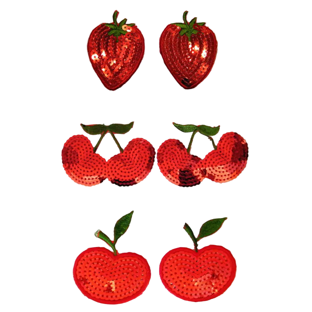 Set of red sequin strawberry and apple decorations on a white background