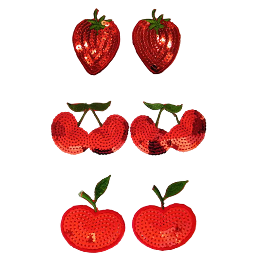 Set of red sequin strawberry and apple decorations on a white background