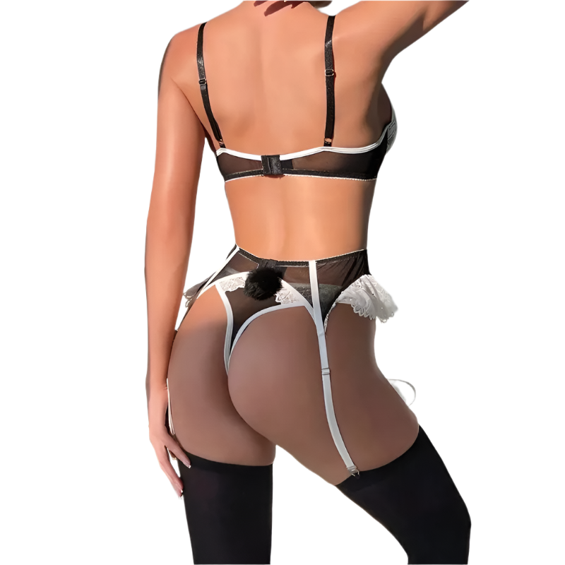 Person wearing a black and white lingerie set with sheer details against a neutral background