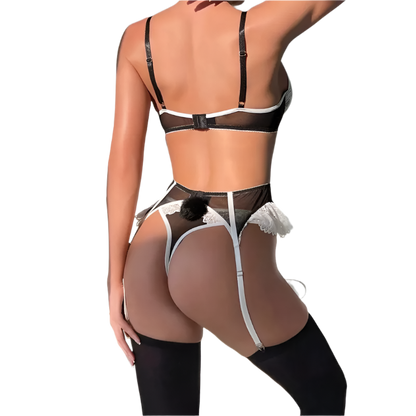 Person wearing a black and white lingerie set with sheer details against a neutral background