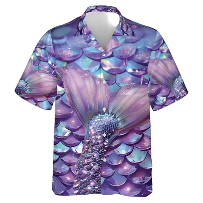A short-sleeve button-up camp shirt featuring an all-over mermaid tail and scale print in shades of purple, blue, and pink, displayed on a clean white background.