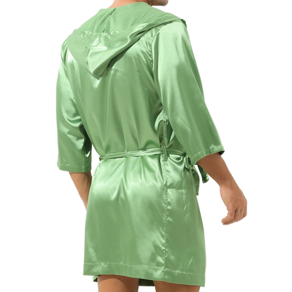 Green raincoat worn by a person on a white background