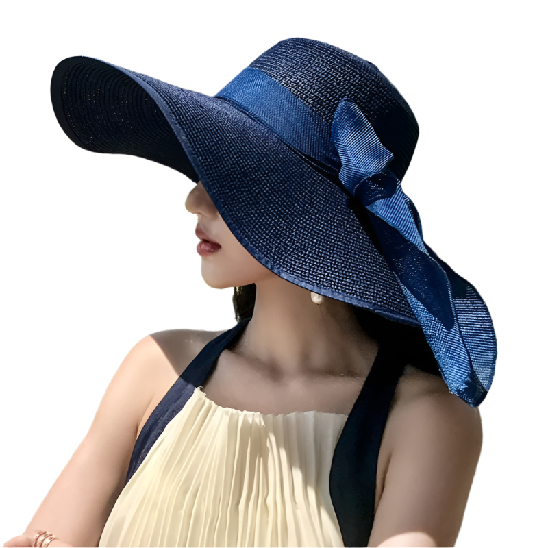 Woman wearing a blue sun hat with a bow, standing outdoors with greenery in the background.