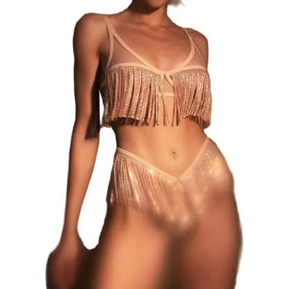 Person wearing a sparkling bikini with fringe details against a dark background