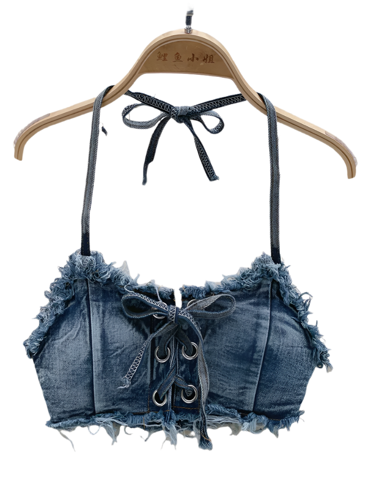 Denim-style crop top with lace-up details on a hanger against a textured background.