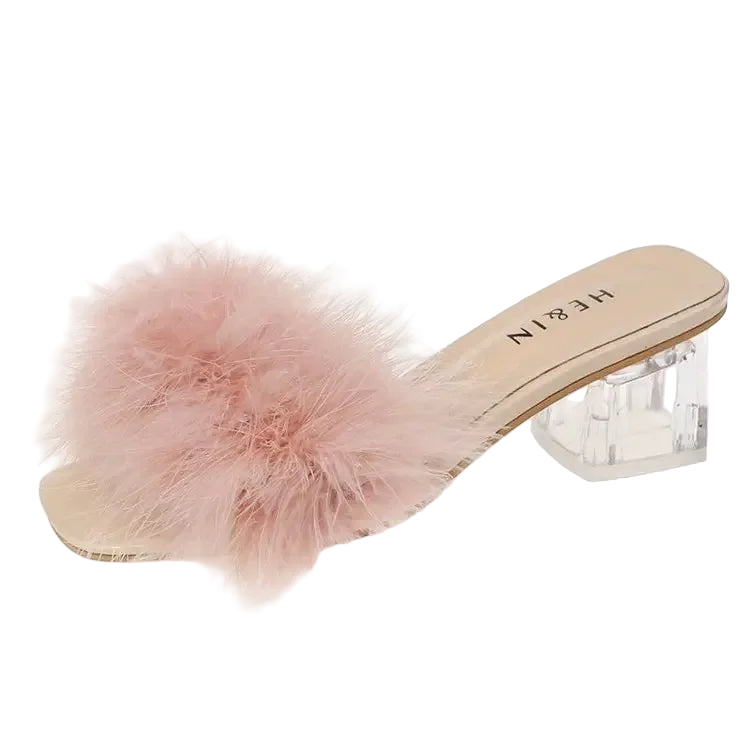 Pink fuzzy slide sandal with clear heel on a white background