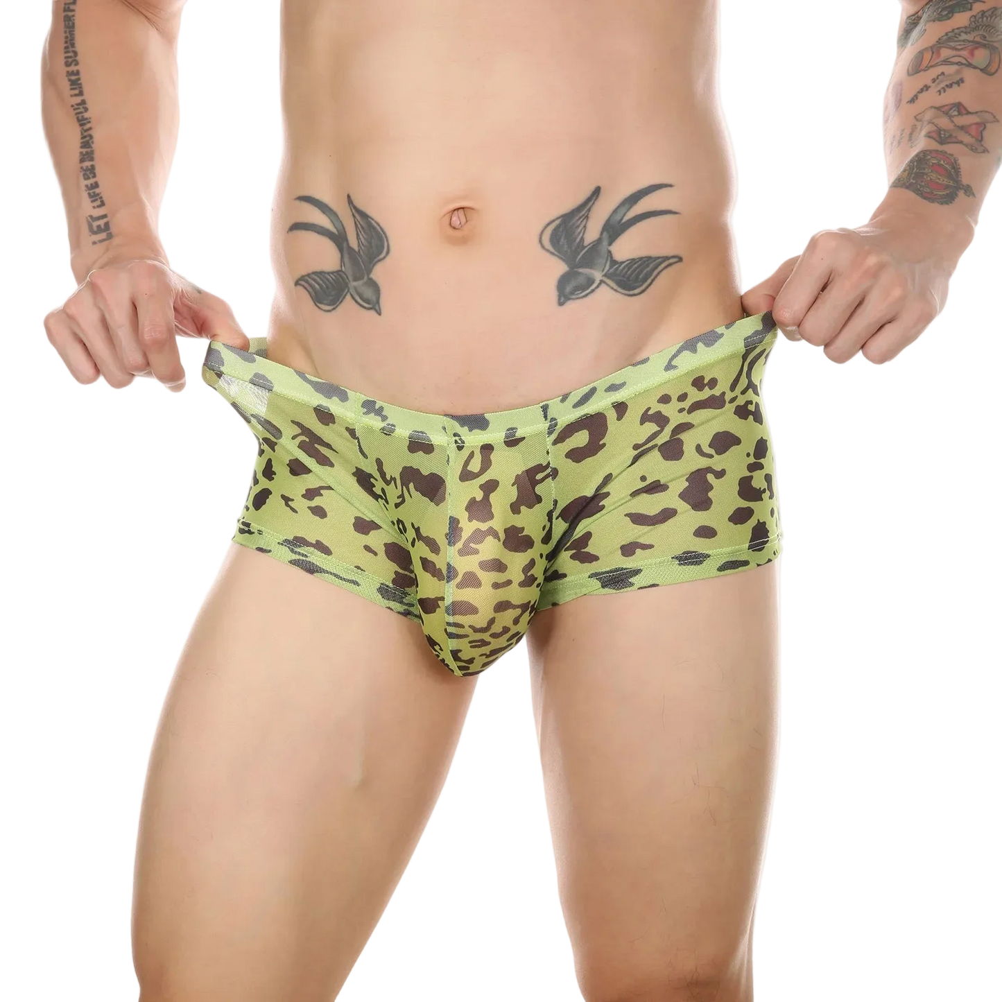 A man wearing low-rise boxer briefs with a green and brown leopard print, holding the waistband outwards to show the fit against a white background.
