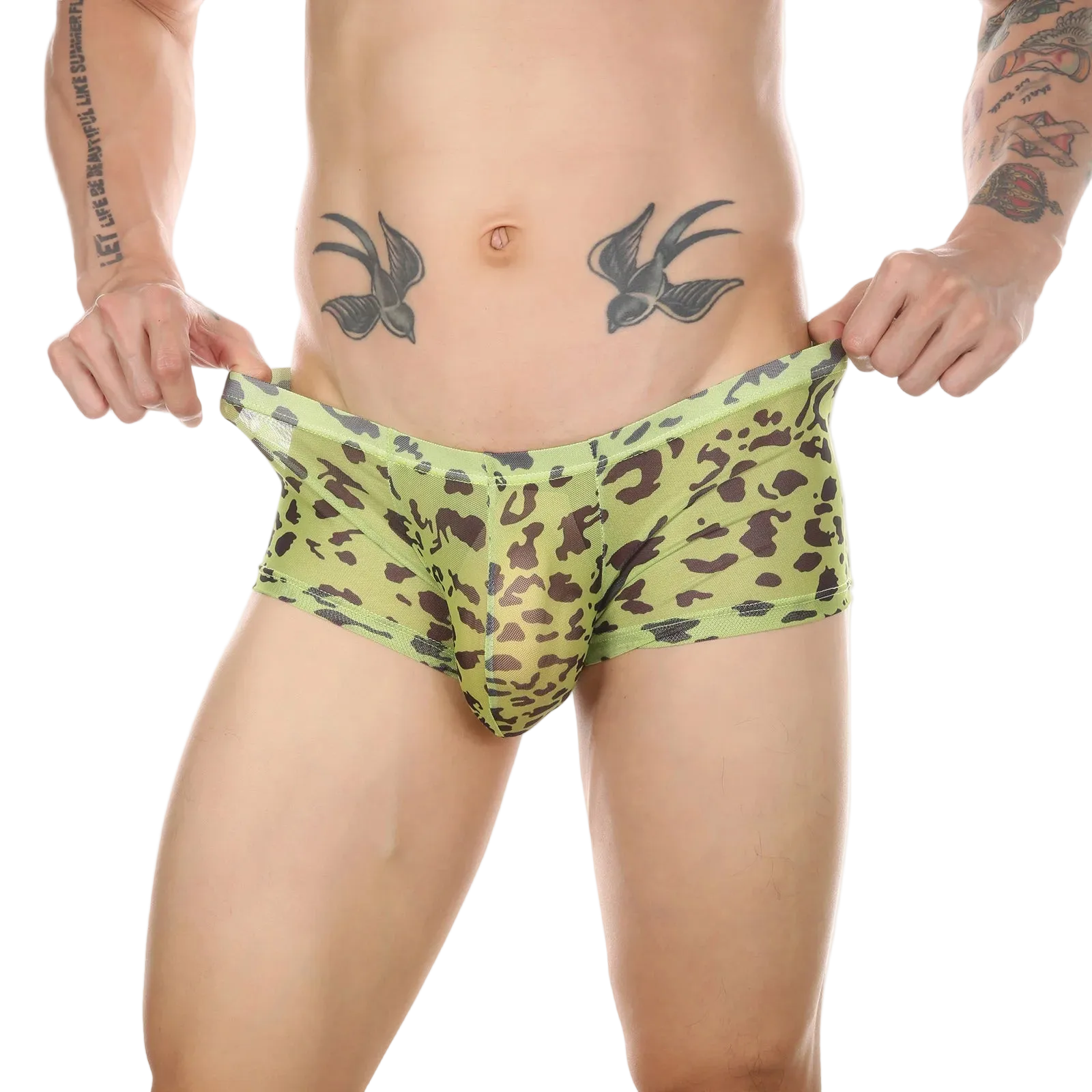 A man wearing low-rise boxer briefs with a green and brown leopard print, holding the waistband outwards to show the fit against a white background.