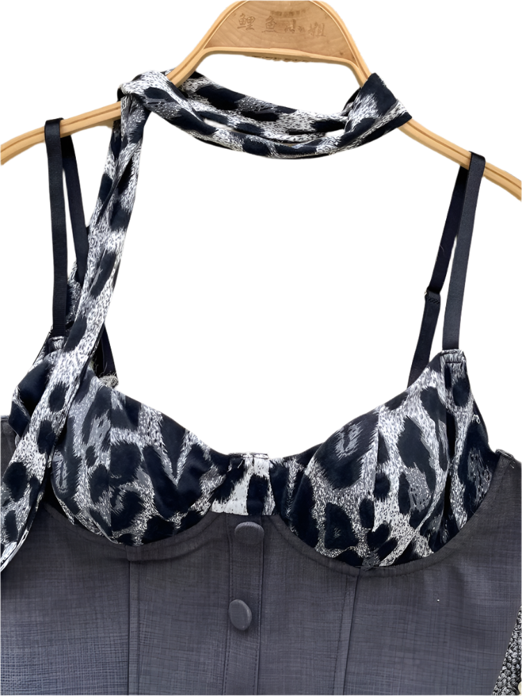 Leopard print bralette on a hanger with a gray garment underneath