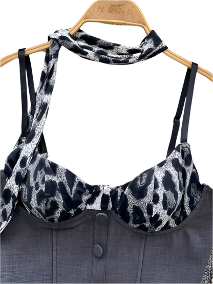 Leopard print bralette on a hanger with a gray garment underneath