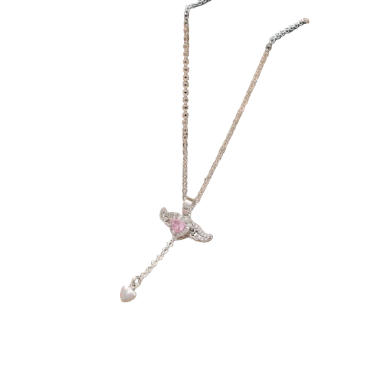 Necklace with a heart-shaped pendant in an open jewelry box on a soft fabric background