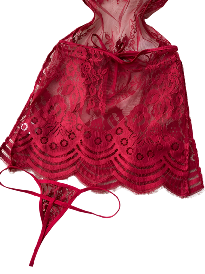 Red lace lingerie set on a white textured surface 