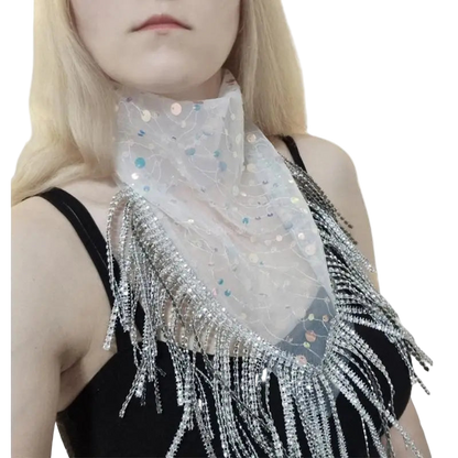 Person wearing a sparkling scarf with fringe on a white background