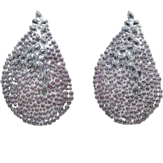 Pair of rhinestone earrings on a white card with a dark background