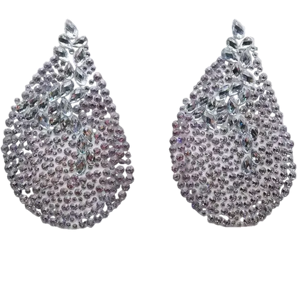 Pair of rhinestone earrings on a white card with a dark background