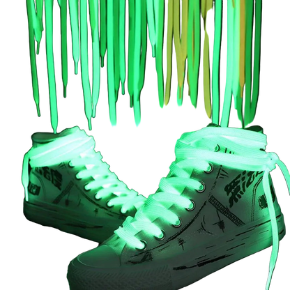 White sneakers with green glowing shoelaces against a dark background
