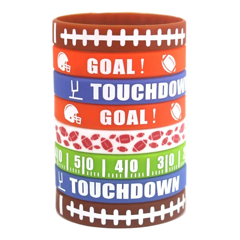 A stack of seven silicone wristbands with football-themed designs, including 'GOAL!' and 'TOUCHDOWN' text, football helmets, footballs, yard line numbers, and football patterns, on a white background.