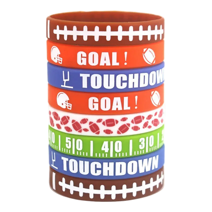 A stack of seven silicone wristbands with football-themed designs, including 'GOAL!' and 'TOUCHDOWN' text, football helmets, footballs, yard line numbers, and football patterns, on a white background.