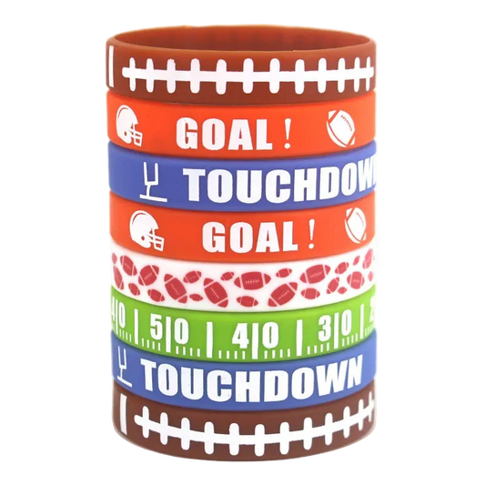A stack of seven silicone wristbands with football-themed designs, including 'GOAL!' and 'TOUCHDOWN' text, football helmets, footballs, yard line numbers, and football patterns, on a white background.