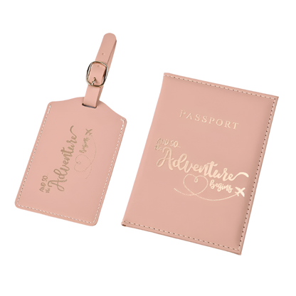 A passport holder and luggage tag set with the phrase "And so the adventure begins" in elegant script. The design is sleek and stylish, perfect for travel.