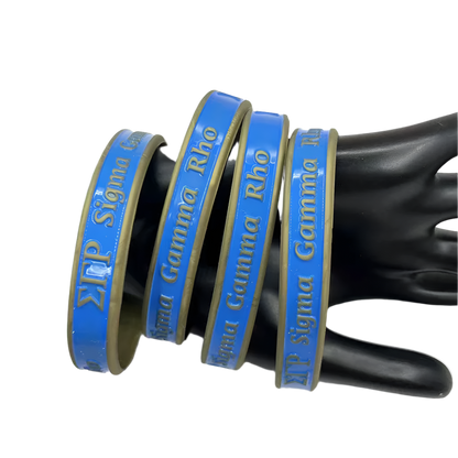Blue and gold ribbons with 'Sigma Gamma Rho' text on a black mannequin hand against a white background.