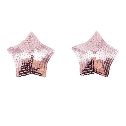 A pair of star-shaped stud earrings covered in rose gold sequins, displayed on a clean white background with a soft reflection underneath.