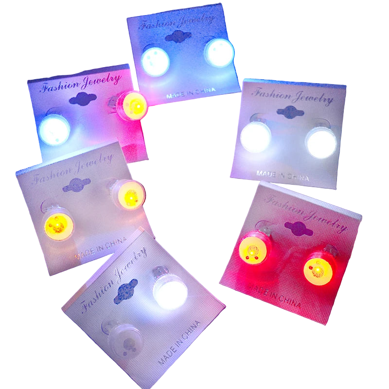 Set of LED earrings on cards with colorful lights against a dark background