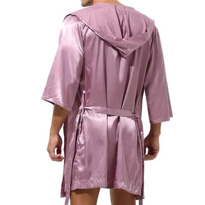 Pink satin robe worn by a person on a white background
