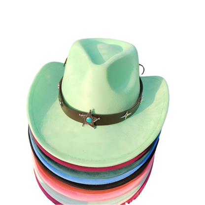 Stack of colorful cowboy hats with a star emblem on a grassy background