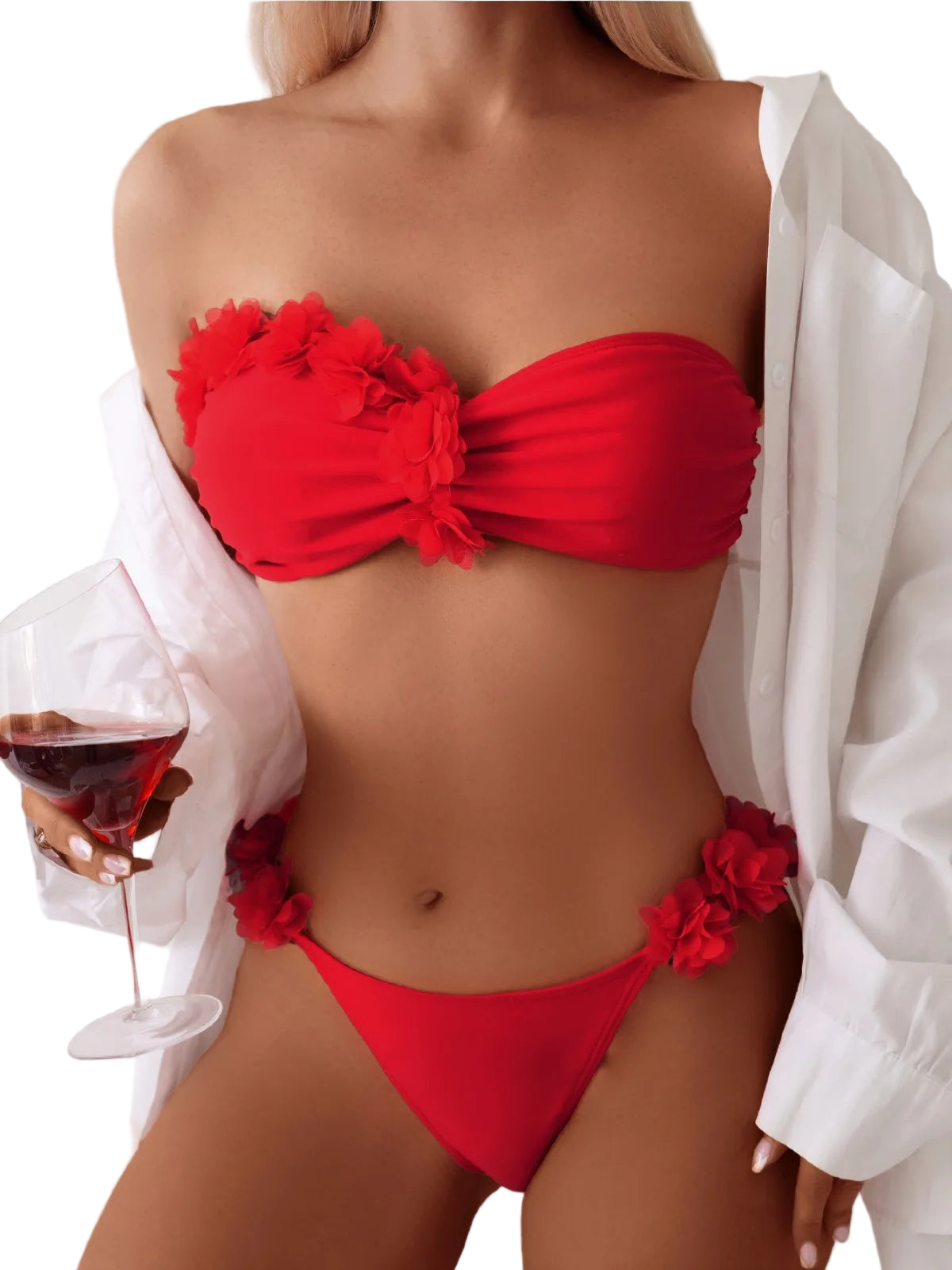 Red bikini with floral details worn by a person holding a glass of red wine.