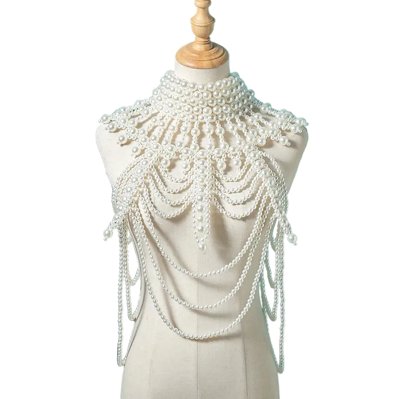 Pearl embellished shoulder piece on a mannequin against a teal background