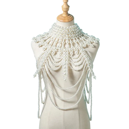 Pearl embellished shoulder piece on a mannequin against a teal background