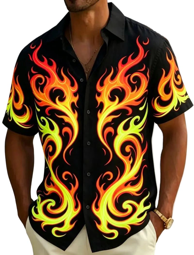 A man wearing a black short-sleeve button-up shirt with a bold flame print in yellow, orange, and red, photographed outdoors with a beach and palm leaves blurred in the background.