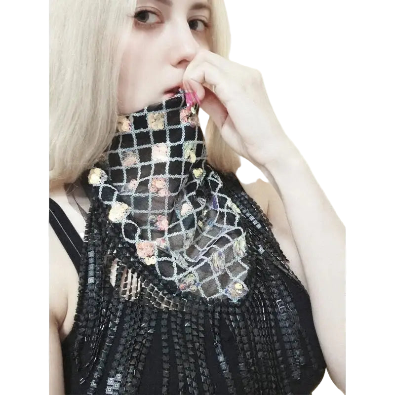 Person wearing a black, textured garment with floral patterns on a white background