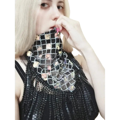 Person wearing a black, textured garment with floral patterns on a white background