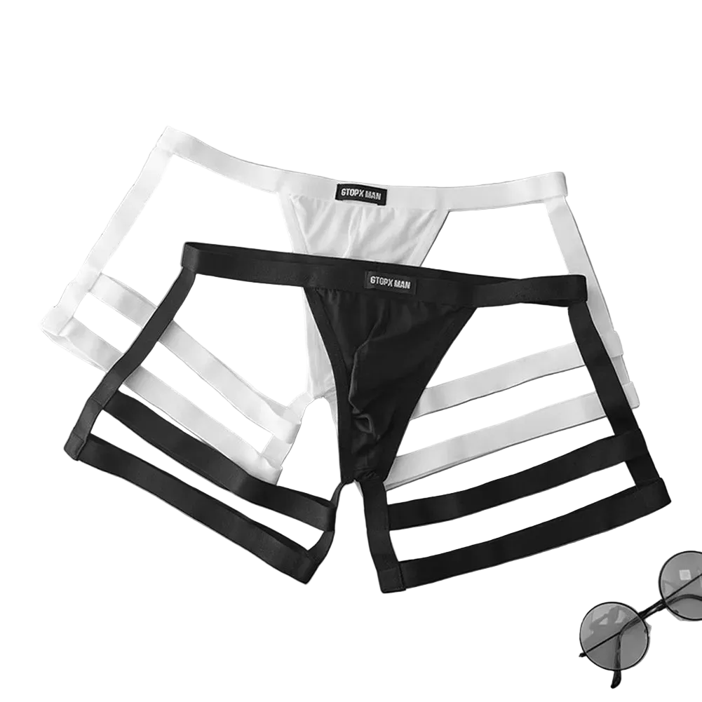 Black and white men's underwear on a gray surface with a grid pattern.