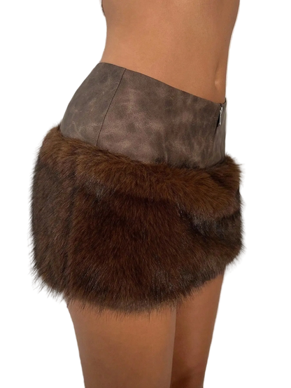 A close-up side view of a model wearing a brown faux fur wrap skirt with a taupe faux leather waistband.