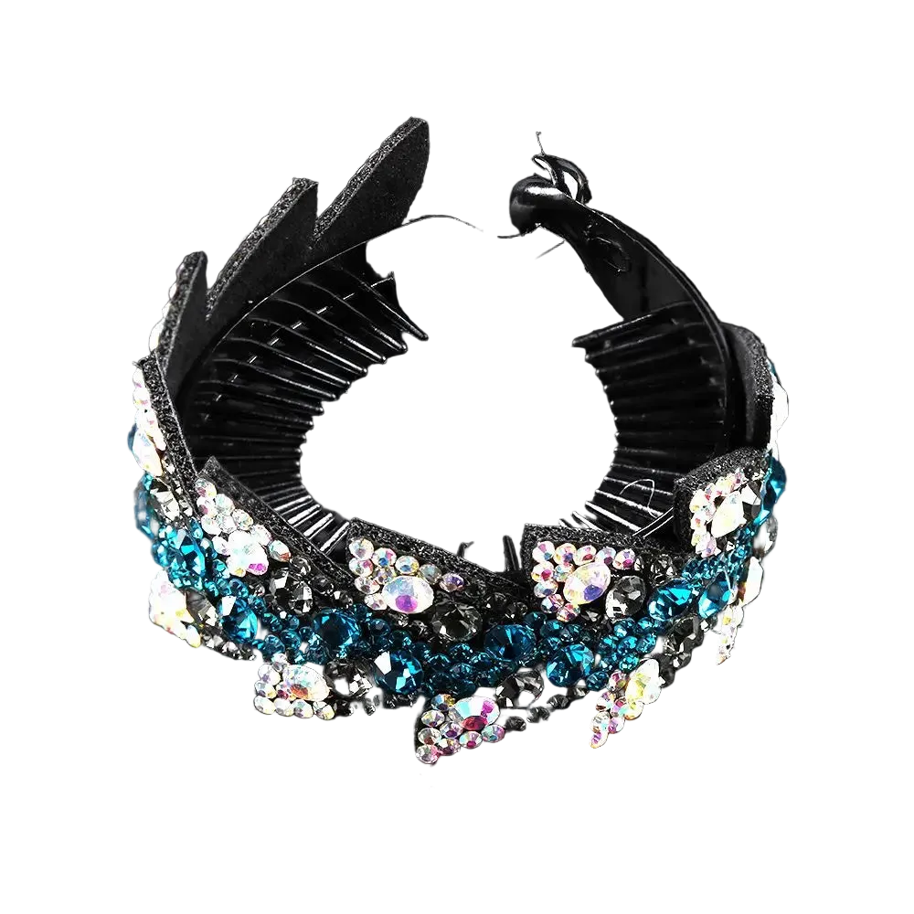 A black plastic claw-style hair comb embellished with blue, white, and iridescent rhinestones, displayed on a reflective black background.
