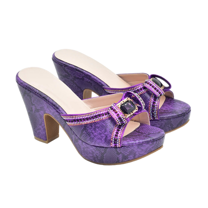 Purple high-heeled shoes with embellishments on a white background