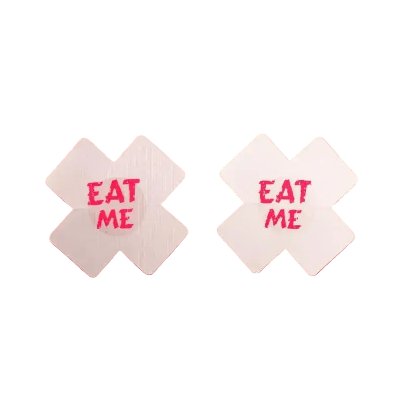 Two white candy wrappers with 'EAT ME' text on a pink background
