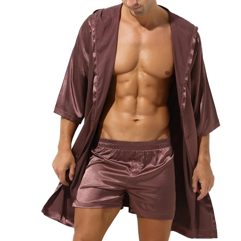 Man wearing a brown satin robe and shorts on a white background