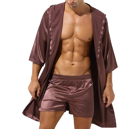 Man wearing a brown satin robe and shorts on a white background