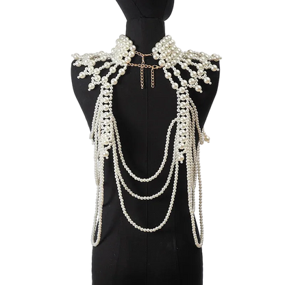 Pearl necklace and shoulder piece on a black mannequin against a white background