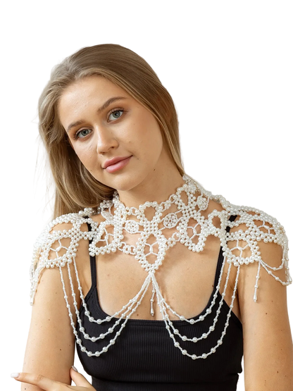 Woman wearing a decorative white pearl garment against a neutral background