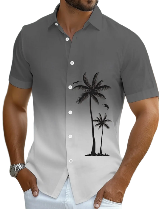 Gray short-sleeve shirt with palm tree design worn by a person.