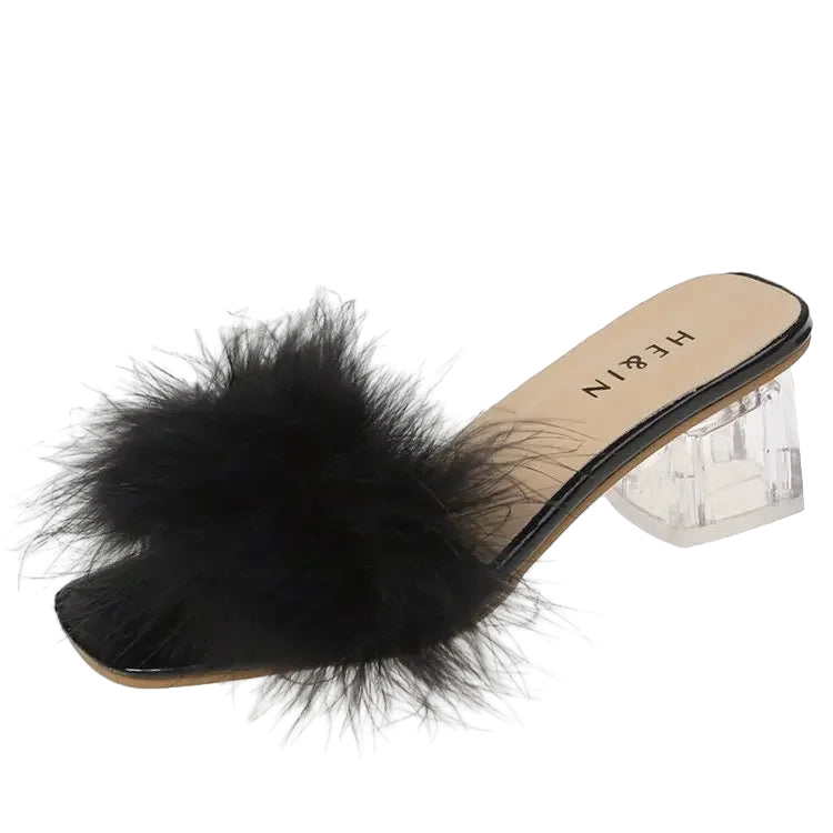 Black feathered slide sandal with clear heel on a white background