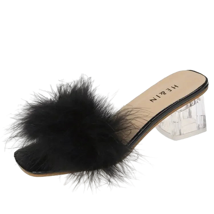 Black feathered slide sandal with clear heel on a white background